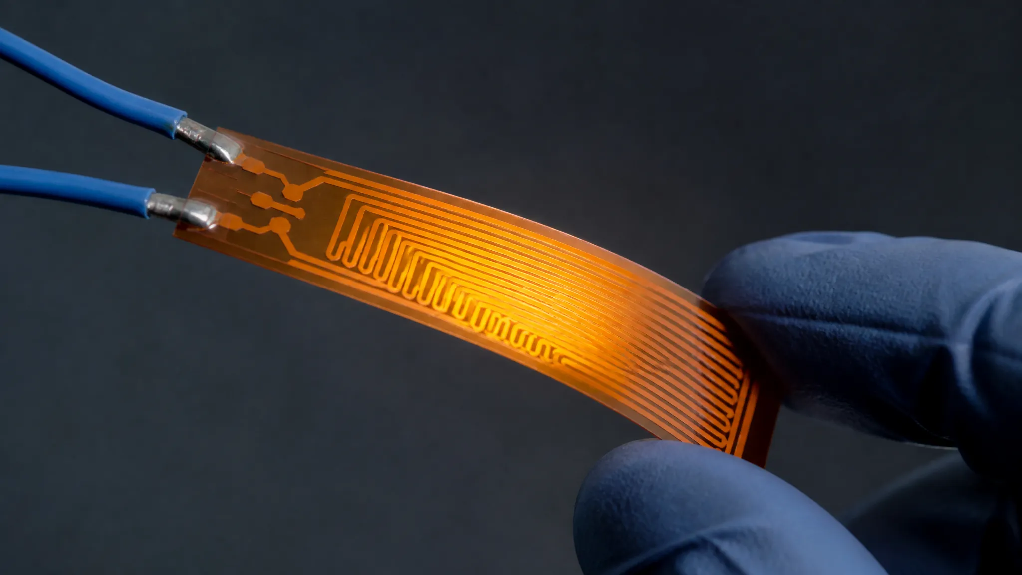 An etched-foil heater element with a profiled circuit pattern that concentrates heat where the surface loses it fastest
