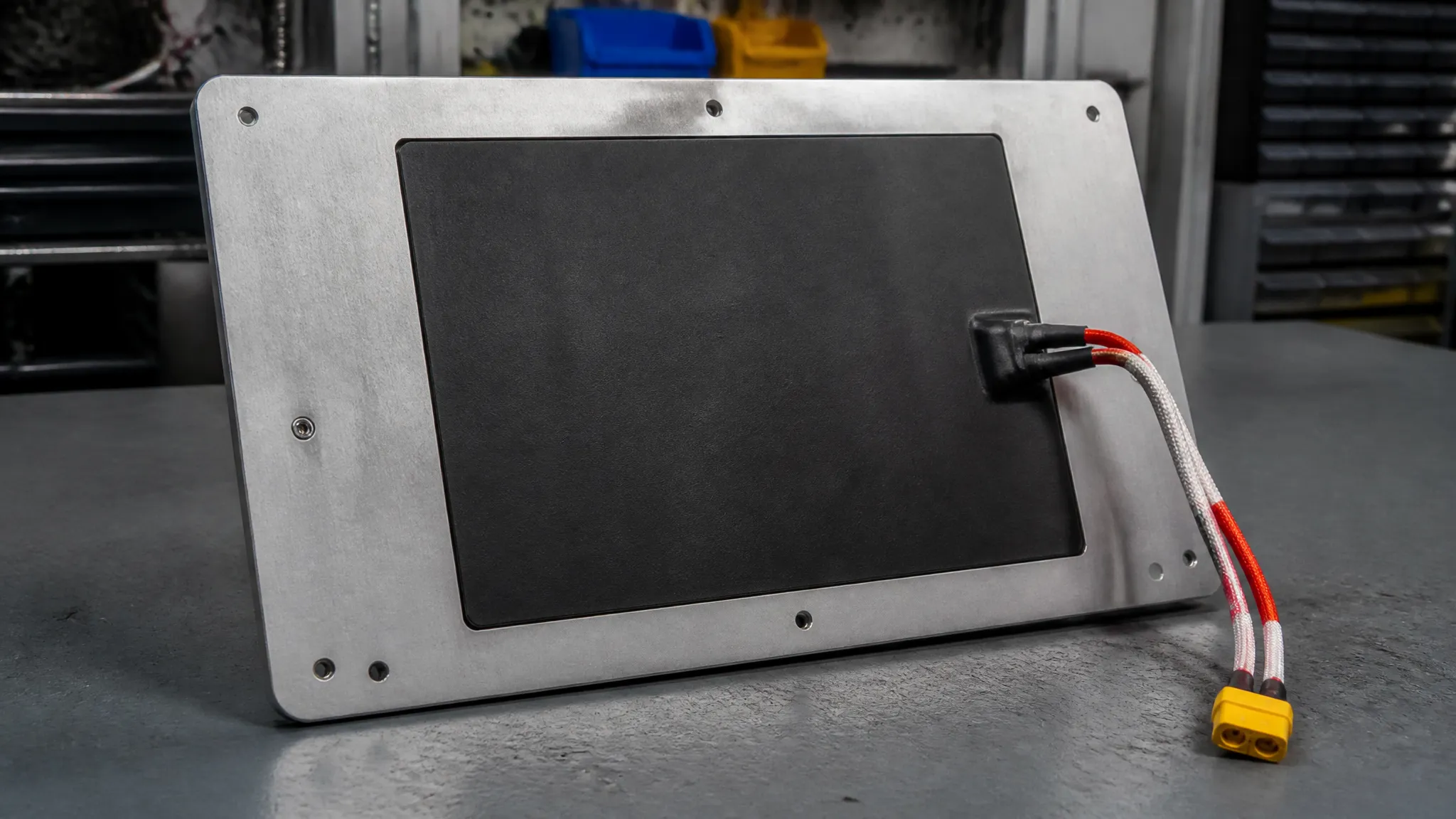 A silicone heater pad bonded beneath the aluminium build plate of a 3D printer