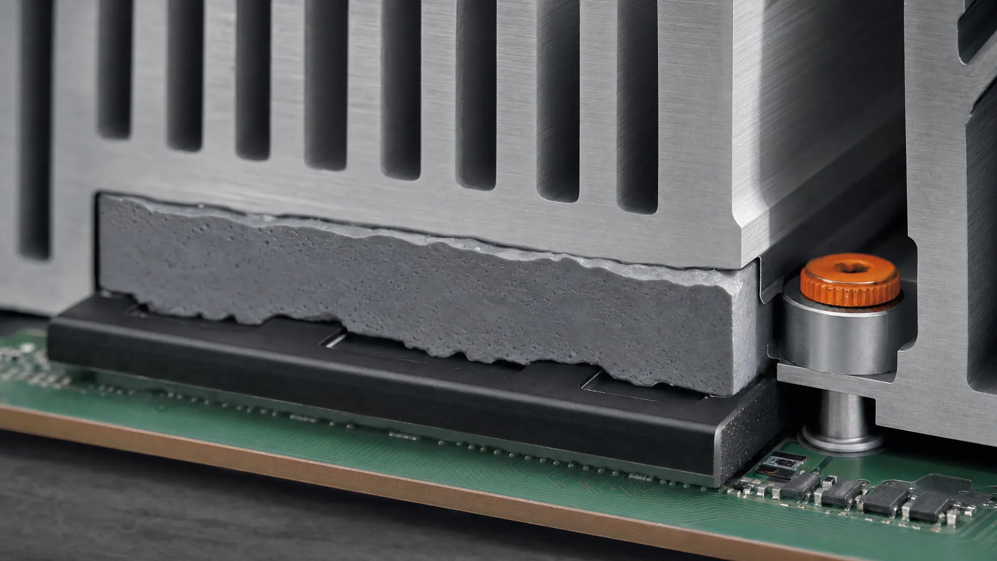 Photorealistic cutaway render of a thermal pad compressed between a chip package and a heat sink, filling the uneven mating surfaces